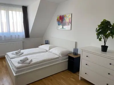 Ein Bett oder Betten in einem Zimmer der Unterkunft Dachgeschoss für 4 mit Terrasse