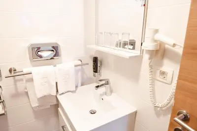 Ein Badezimmer in der Unterkunft Primus Hotel & Apartments