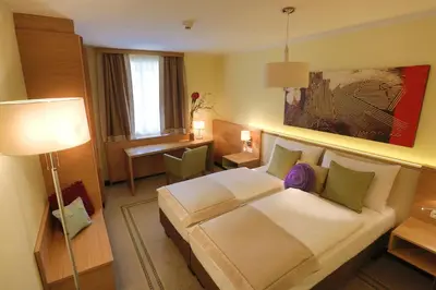 Ein Bett oder Betten in einem Zimmer der Unterkunft Hotel Leobersdorfer Hof