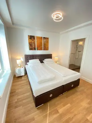 Ein Bett oder Betten in einem Zimmer der Unterkunft Pelikan Apartments