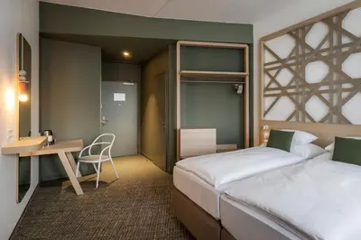 Ein Bett oder Betten in einem Zimmer der Unterkunft ARCOTEL AQ Wien