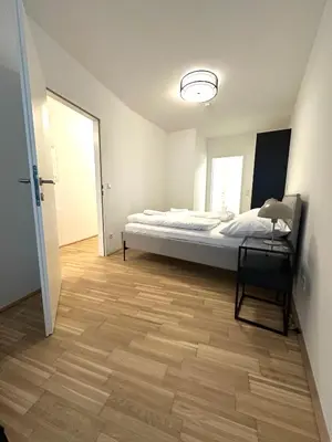 Ein Bett oder Betten in einem Zimmer der Unterkunft COHO City Apartments mit hauseigener Tiefgarage
