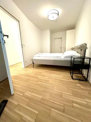 Ein Bett oder Betten in einem Zimmer der Unterkunft COHO City Apartments mit hauseigener Tiefgarage