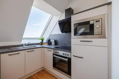 Küche/Küchenzeile in der Unterkunft SYMPHONY Apartments 38 - Modern Loft with Terrace and Grill in Central Location