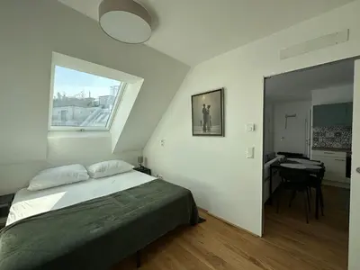 Ein Bett oder Betten in einem Zimmer der Unterkunft FeelHome-Dachterrasse-4 Gäste-WiFi