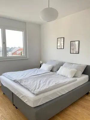 Ein Bett oder Betten in einem Zimmer der Unterkunft Neubauwohnung Wien Donaustadt