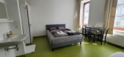 Ein Bett oder Betten in einem Zimmer der Unterkunft Tota K