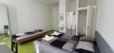 Ein Bett oder Betten in einem Zimmer der Unterkunft Tota K