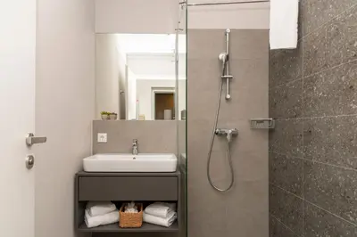 Ein Badezimmer in der Unterkunft HANS-Y Apartments inklusive Outdoorpool & Bar
