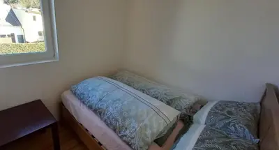 Ein Bett oder Betten in einem Zimmer der Unterkunft Gästewohnung mit Terrasse 