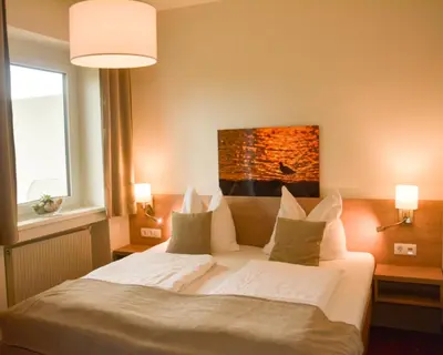 Ein Bett oder Betten in einem Zimmer der Unterkunft Hotel Am Greiner