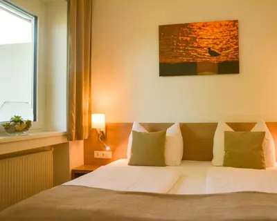 Ein Bett oder Betten in einem Zimmer der Unterkunft Hotel Am Greiner