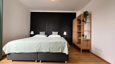 Ein Bett oder Betten in einem Zimmer der Unterkunft Moderne OG Wohnung inklusive Dachterrasse