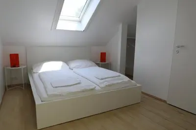 Ein Bett oder Betten in einem Zimmer der Unterkunft Storchencamp Gästehaus Purbach