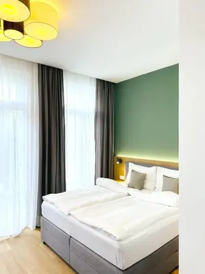Ein Bett oder Betten in einem Zimmer der Unterkunft Villa Romana Apartments