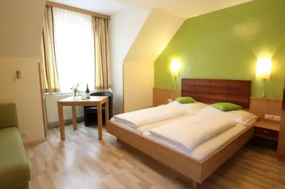Ein Bett oder Betten in einem Zimmer der Unterkunft Pension Joseph Haydn