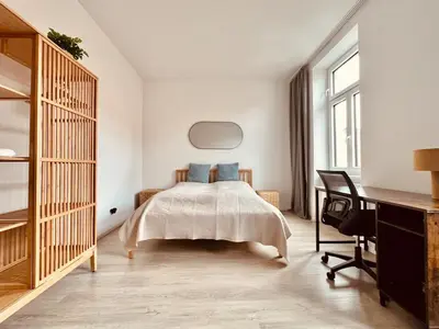 Ein Bett oder Betten in einem Zimmer der Unterkunft SERVUS HOMES - Metro Stadthalle - SOUND OF MUSIC