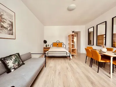 Ein Bett oder Betten in einem Zimmer der Unterkunft SERVUS HOMES - Metro Stadthalle - SOUND OF MUSIC