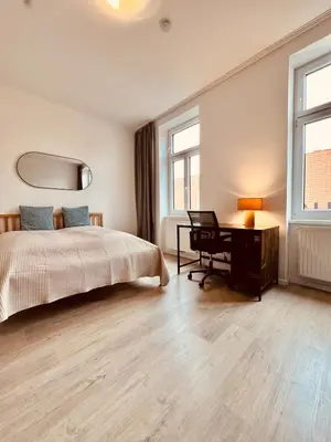Ein Bett oder Betten in einem Zimmer der Unterkunft SERVUS HOMES - Metro Stadthalle - SOUND OF MUSIC