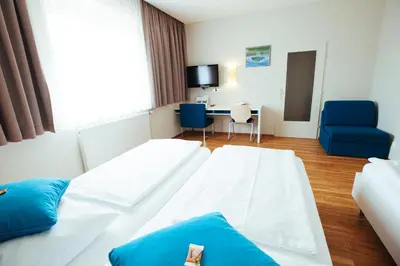 Ein Bett oder Betten in einem Zimmer der Unterkunft KSV Hotel Wien