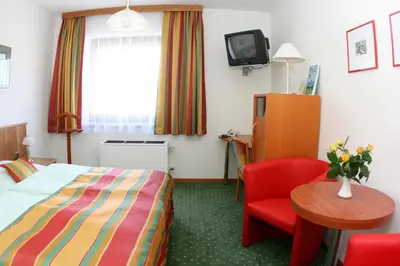 Ein Bett oder Betten in einem Zimmer der Unterkunft Turmhof Breitenbrunn