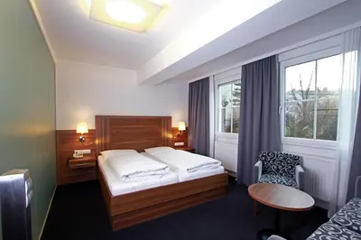 Ein Bett oder Betten in einem Zimmer der Unterkunft Pension am Kurpark