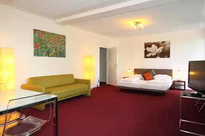 Ein Bett oder Betten in einem Zimmer der Unterkunft College Garden Hotel