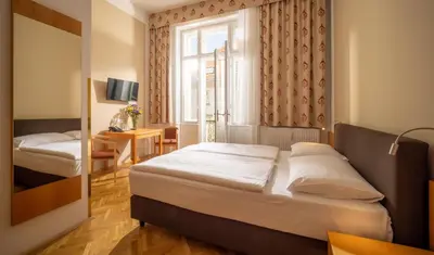 Ein Bett oder Betten in einem Zimmer der Unterkunft Hotel Post Wien