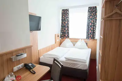 Ein Bett oder Betten in einem Zimmer der Unterkunft Pension Dr. Geissler