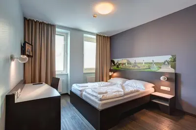 Ein Bett oder Betten in einem Zimmer der Unterkunft MEININGER Hotel Wien Downtown Sissi