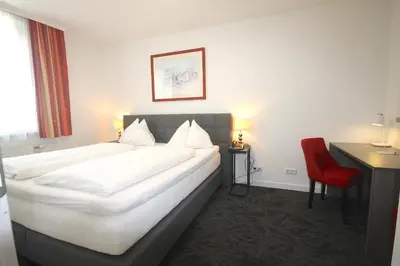 Ein Bett oder Betten in einem Zimmer der Unterkunft Hotel Altmann