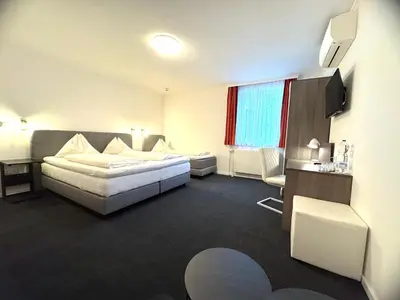 Ein Bett oder Betten in einem Zimmer der Unterkunft Hotel Altmann