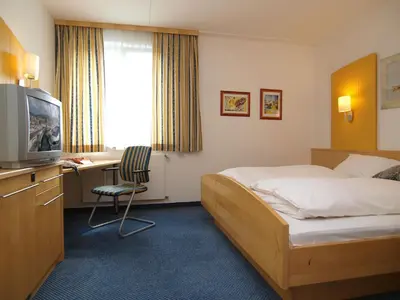 Ein Bett oder Betten in einem Zimmer der Unterkunft Gastwirtschaft & Hotel Holzinger