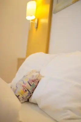 Ein Bett oder Betten in einem Zimmer der Unterkunft Gastwirtschaft & Hotel Holzinger