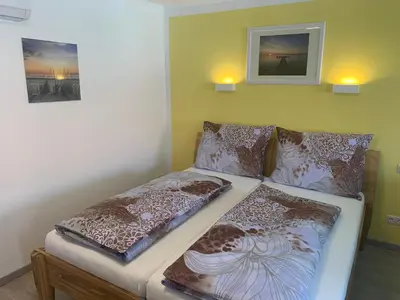 Ein Bett oder Betten in einem Zimmer der Unterkunft Ferienwohnungen zum Briefmarkenhaus