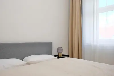 Ein Bett oder Betten in einem Zimmer der Unterkunft Triple A Apartments