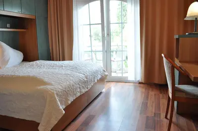 Ein Bett oder Betten in einem Zimmer der Unterkunft Seehotel Herlinde
