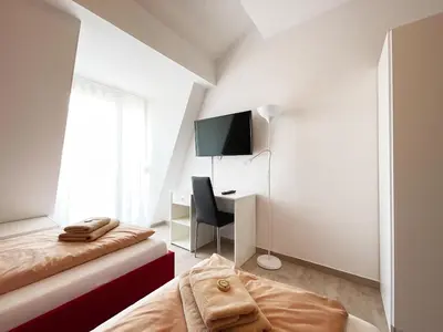 Ein Bett oder Betten in einem Zimmer der Unterkunft Pension Voesendorf