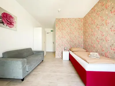 Ein Bett oder Betten in einem Zimmer der Unterkunft Pension Voesendorf