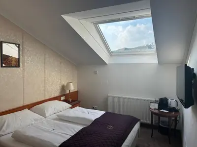 Ein Bett oder Betten in einem Zimmer der Unterkunft Hotel Am Schubertring