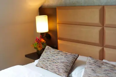 Ein Bett oder Betten in einem Zimmer der Unterkunft Drei Kronen Hotel Wien City