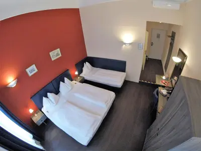Ein Bett oder Betten in einem Zimmer der Unterkunft Hotel Pension Excellence