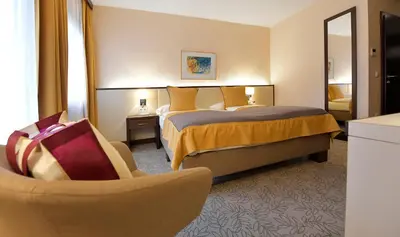 Ein Bett oder Betten in einem Zimmer der Unterkunft Seehotel Rust