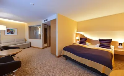 Ein Bett oder Betten in einem Zimmer der Unterkunft Seehotel Rust