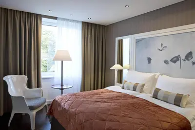 Ein Bett oder Betten in einem Zimmer der Unterkunft The Harmonie Vienna, BW Premier Collection