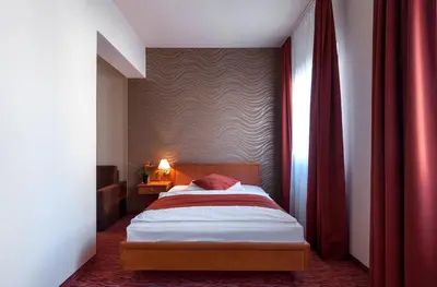 Ein Bett oder Betten in einem Zimmer der Unterkunft Club Hotel Cortina