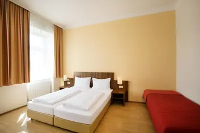 Ein Bett oder Betten in einem Zimmer der Unterkunft Hahn Hotel Vienna