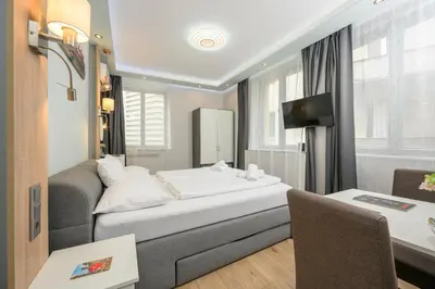Ein Bett oder Betten in einem Zimmer der Unterkunft Palais Pálffy Apartments Vienna