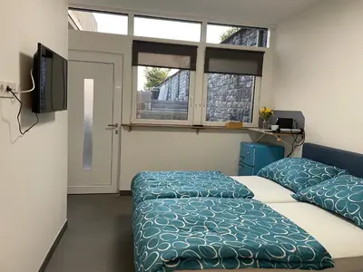 Ein Bett oder Betten in einem Zimmer der Unterkunft Sandy’s Home