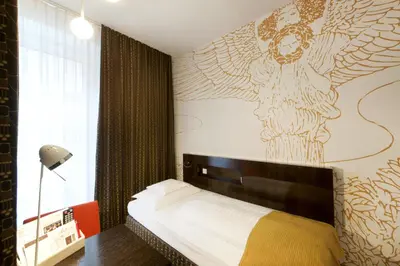 Ein Bett oder Betten in einem Zimmer der Unterkunft Alma Boutique-Hotel